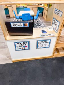preschool library dramatic play center with computer to check out books