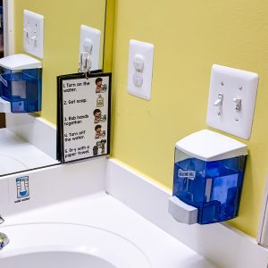 A student bathroom with visual cue card for handwashing