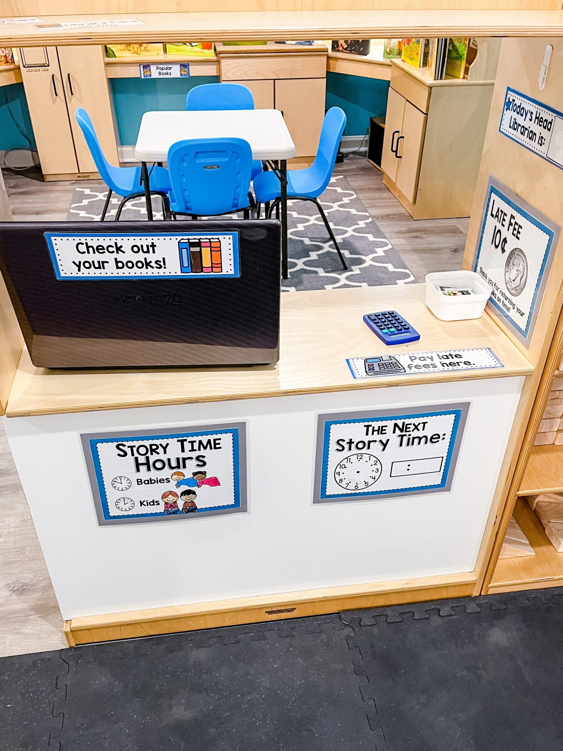 preschool library dramatic play center with computer to check out books
