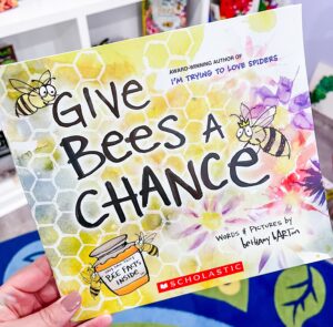 Cover of Give Bees a Chance by Bethany Barton, with bold text and a close-up cartoon bee against a yellow background.
