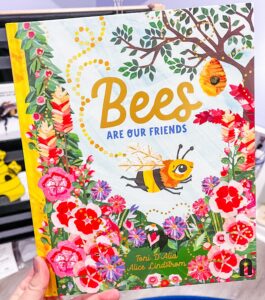 Cover of Bees Are Our Friends by Toni D’Alia, featuring a cheerful bee flying above flowers in soft, child-friendly illustrations.