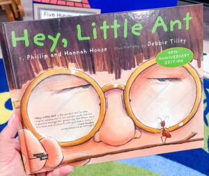 Cover of Hey, Little Ant by Phillip and Hannah Hoose, with a close-up of a boy’s eyes with glasses looking at a small ant.