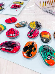 River rocks painted by preschoolers to look like different types of ladybugs.