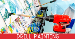 A child in a blue smock uses a toy drill with a paintbrush attached to create art on a vertical surface. Multiple cups of colorful paint and several paintbrushes are visible, along with abstract painted designs on the paper. The words "Drill Painting" appear in large white letters on a red banner at the bottom of the image.