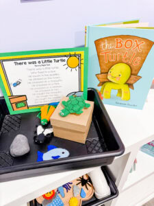 There Was a Little Turtle preschool retelling tray with turtle and insect props, a printed rhyme card, and the book The Box Turtle.