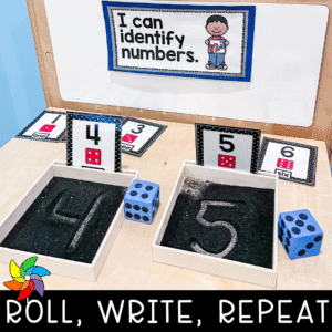 Preschool math center with dice and sand writing trays.