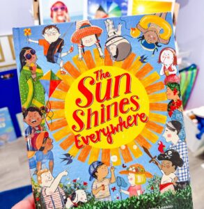 Cover of the book The Sun Shines Everywhere by Mary Ann Hoberman, illustrated with children from around the world enjoying the sunshine.
