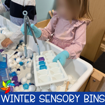 Winter sensory bins for preschool with white pom pom snow, blue ice cubes, ice cube trays, tongs, and fine motor tools set up in a sensory table.
