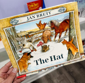The Hat by Jan Brett displayed as a winter book for preschool with detailed animal illustrations